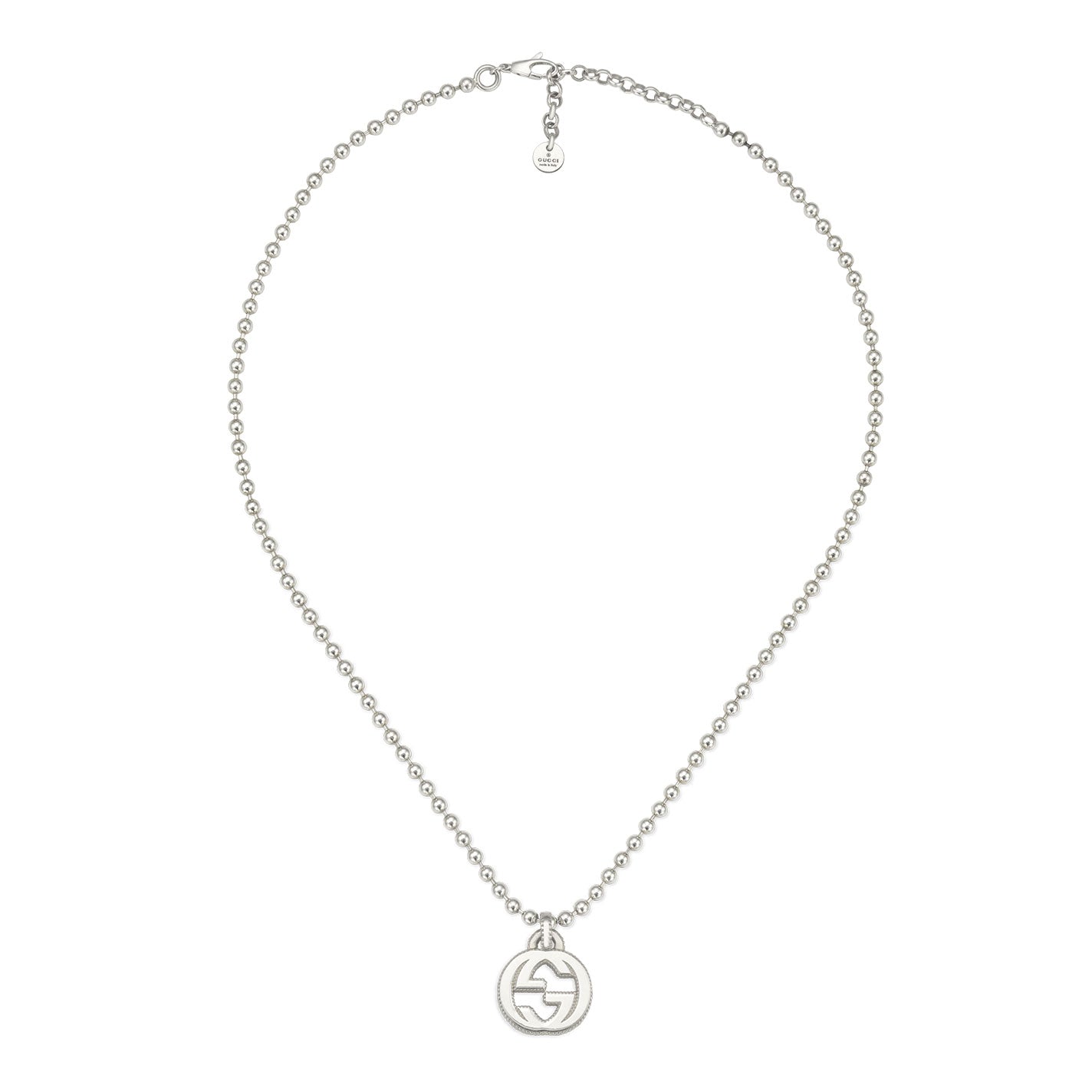 The Gucci Interlocking G Sterling Silver Necklace Pendant from GUCCI Fine Jewellery showcases small, evenly spaced beads and a round pendant featuring the iconic interlocking G design. Crafted from sterling silver, it is finished with a straightforward clasp and a small tag positioned near the closure.