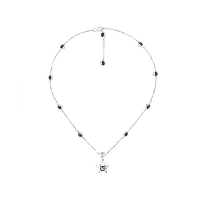 The Gucci Blind For Love Sterling Silver Necklace Pendant from GUCCI Fine Jewellery features a star-shaped pendant with a circular design in the middle. Its silver chain is embellished with evenly spaced black gemstones and includes an adjustable clasp, offering a simple yet elegant style.