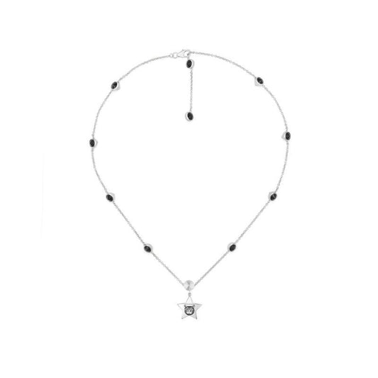 The Gucci Blind For Love Sterling Silver Necklace Pendant from GUCCI Fine Jewellery features a star-shaped pendant with a circular design in the middle. Its silver chain is embellished with evenly spaced black gemstones and includes an adjustable clasp, offering a simple yet elegant style.