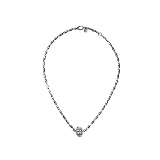 Introducing the Gucci G Cube Sterling Silver Necklace from GUCCI Fine Jewellery. This exquisite piece features a sophisticated design with a small cube pendant in the center, showcasing intricate detailing and understated crystals. The necklace includes a clasp at the top and is perfect for everyday elegance, set against a plain white background.