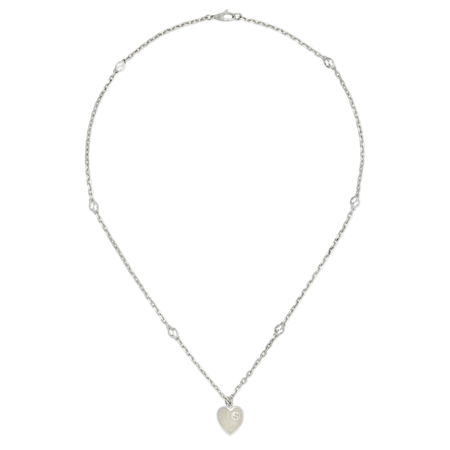 The Gucci Interlocking G Sterling Silver Heart Enamel Necklace from GUCCI Fine Jewellery features a delicate 925 silver chain, small round beads, and an interlocking G heart pendant with engraved design and mother of pearl effect enamel.