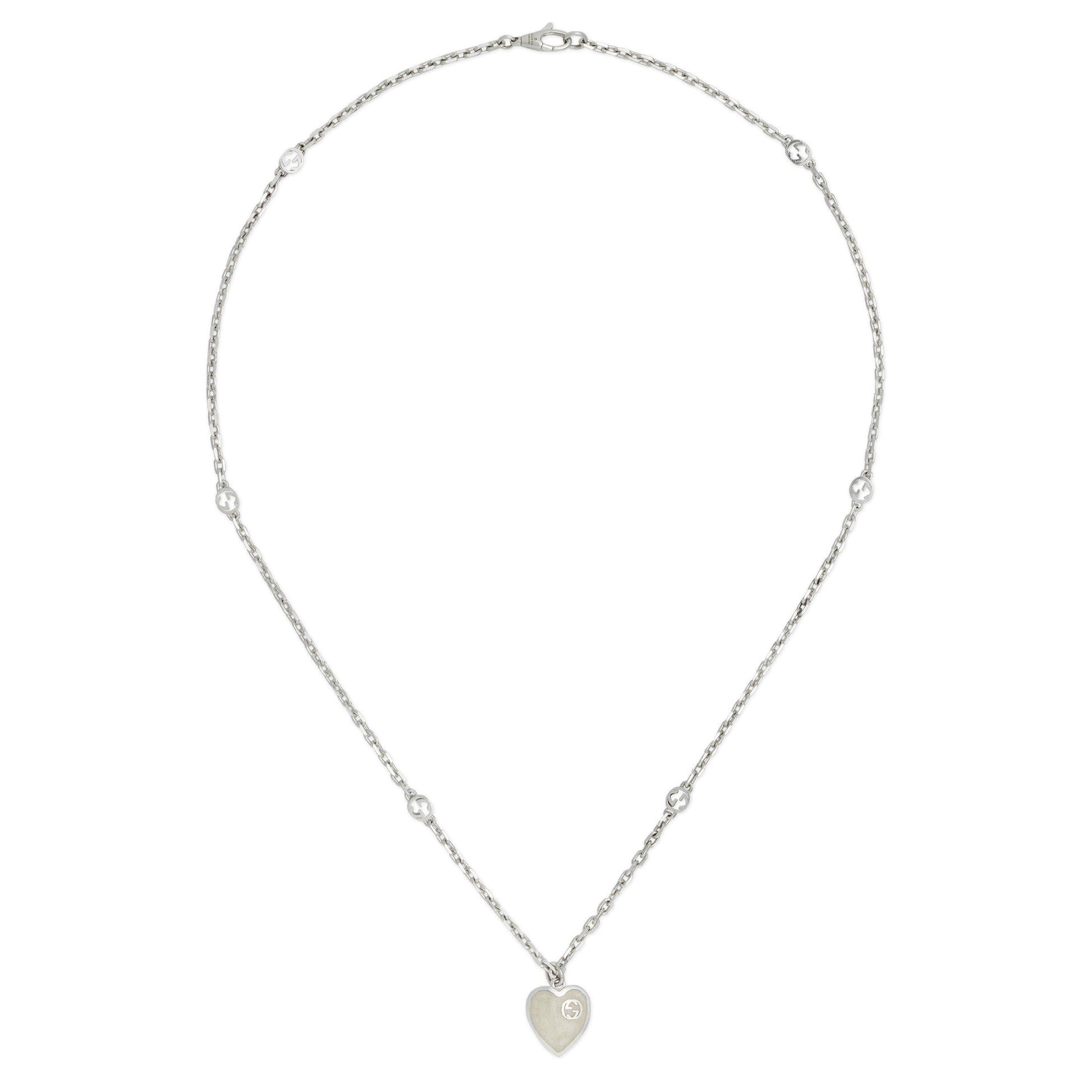 The Gucci Interlocking G Sterling Silver Heart Enamel Necklace from GUCCI Fine Jewellery features a delicate 925 silver chain, small round beads, and an interlocking G heart pendant with engraved design and mother of pearl effect enamel.