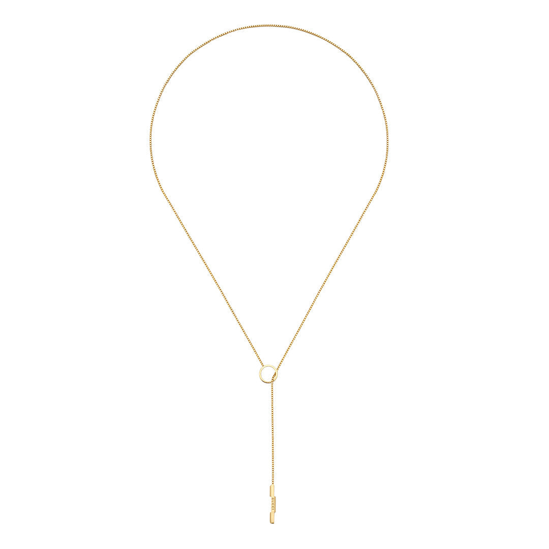 The Gucci Link To Love 18K Yellow Gold Lariat Necklace from GUCCI Fine Jewellery features a delicate chain with a central circular loop and vertical bar drop, offering a timeless, sustainably inspired design.