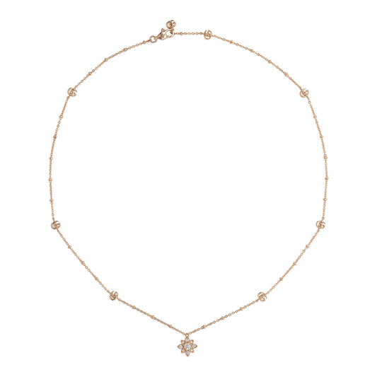 The Gucci Flora 18K Rosé Gold Diamond Station Necklace Pendant by GUCCI Fine Jewellery is a refined piece featuring a delicate rose gold chain adorned with several tiny round diamond stations and a small star-shaped pendant, embodying the elegance of the Gucci Flora collection.