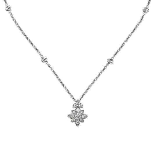 Introducing the Gucci Flora 18K White Gold Diamond Station Necklace Pendant from GUCCI Fine Jewellery, a stunning piece reminiscent of the iconic Flora collection. The floral pendant features petals encrusted with delicate diamonds, offering a radiant sparkle. Crafted in 18K white gold, the elegant chain is adorned with small diamond clusters for an exquisitely refined look.