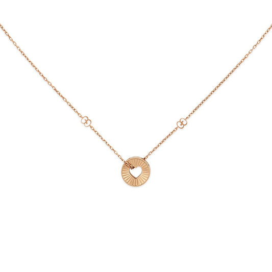 The Gucci Icon Heart 18K Rose Gold Necklace Pendant by GUCCI Fine Jewellery is a delicate piece featuring a circular heart pendant with a charming cutout design. The necklace chain is adorned with small decorative circles flanking the pendant, all set against a plain white background.