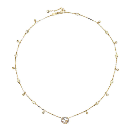 The Gucci Interlocking G 18K Yellow Gold Diamond Necklace by GUCCI Fine Jewellery showcases exquisite craftsmanship, featuring small circular embellishments elegantly spaced along its chain. At the center, a stunning circular pendant adorned with diamonds in an abstract design provides a touch of sophistication and allure.