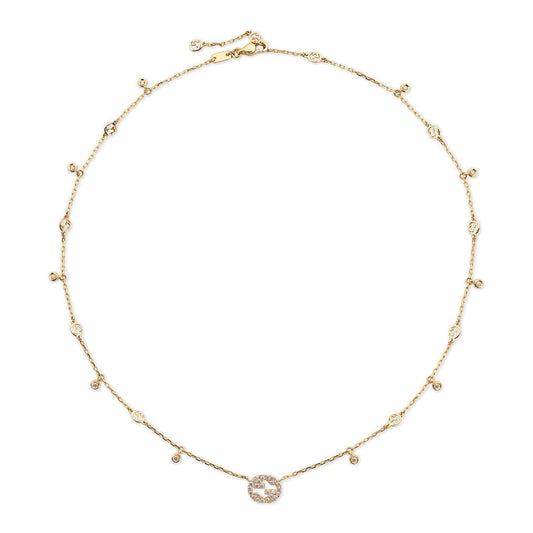 The Gucci Interlocking G 18K Yellow Gold Diamond Station Necklace Pendant by GUCCI Fine Jewellery features diamond accents along the chain and a diamond-encrusted Interlocking G circular pendant—a stunning diamond jewelry piece.