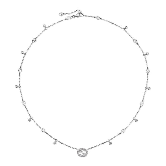 The Gucci Interlocking G 18K White Gold Diamond Necklace from GUCCI Fine Jewellery showcases a refined design with a central round pendant adorned with small diamonds and smaller diamonds evenly distributed along the chain.