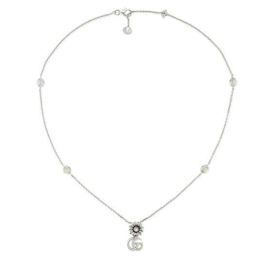 The Gucci GG Marmont Sterling Silver Necklace from GUCCI Fine Jewellery showcases a sun-shaped charm with the iconic double "G" logo and features evenly spaced mother-of-pearl beads along its chain.