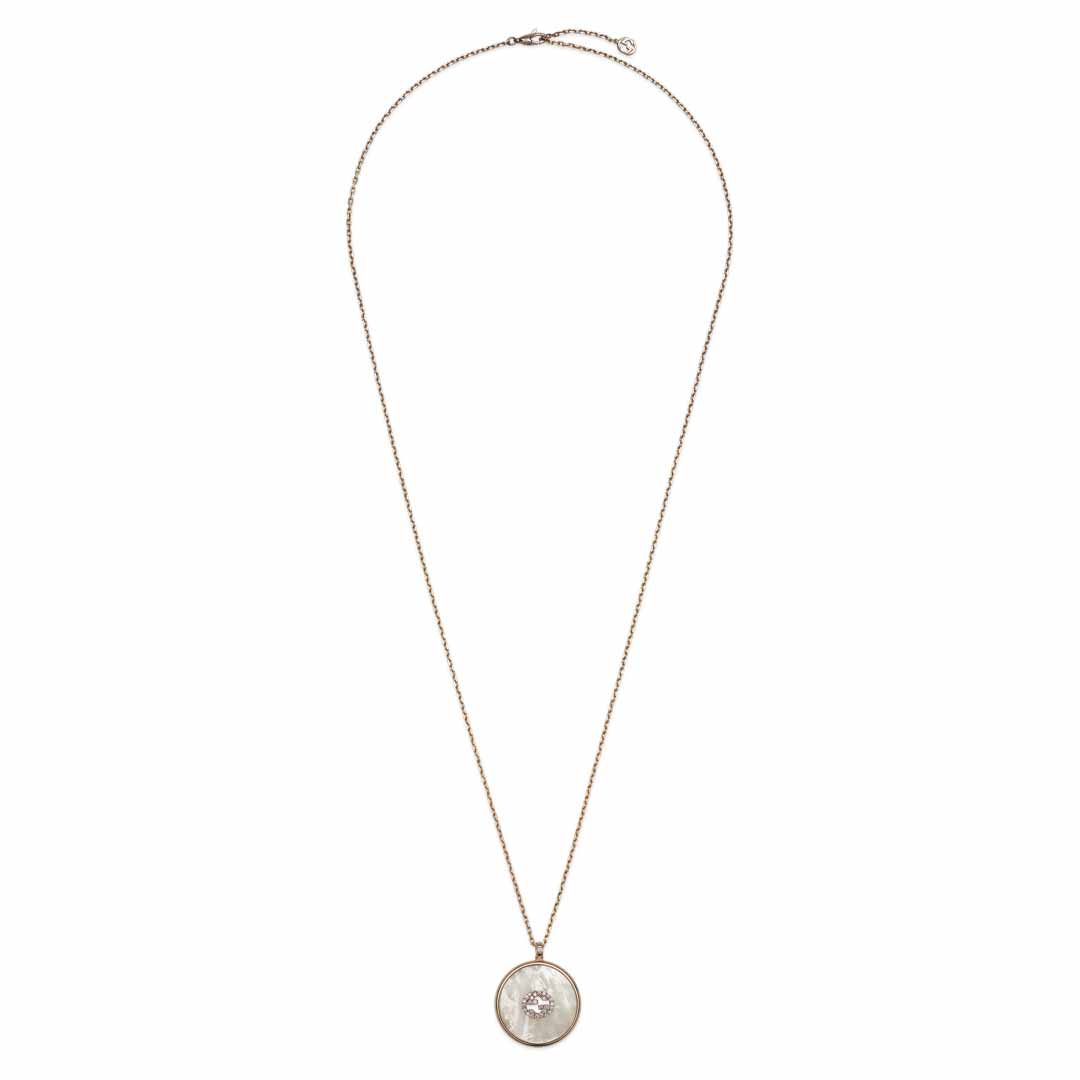 The Gucci 18K Rose Gold Diamond Necklace Pendant from GUCCI Fine Jewellery showcases a thin chain with a round pendant intricately detailed with a sculpted figure. The GG motif enhances its elegance, adding a luxurious touch against the white background.