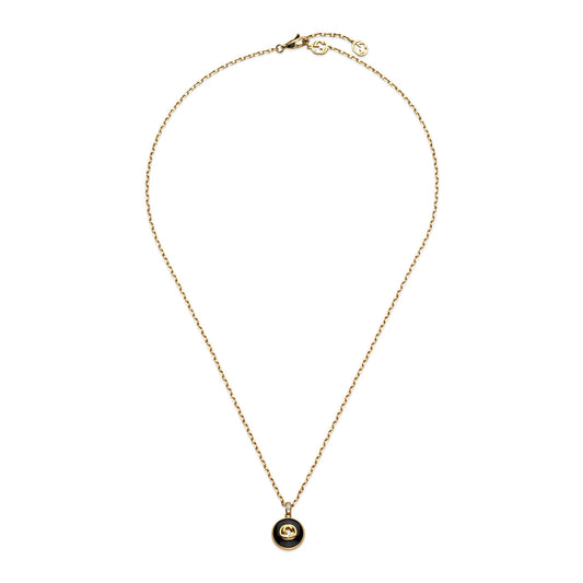 The Gucci Interlocking 18K Yellow Gold Chain Necklace by GUCCI Fine Jewellery features a small, round black onyx pendant with a gold logo emblem at the center, gracefully hanging from the chain and beautifully displayed on a plain white background.