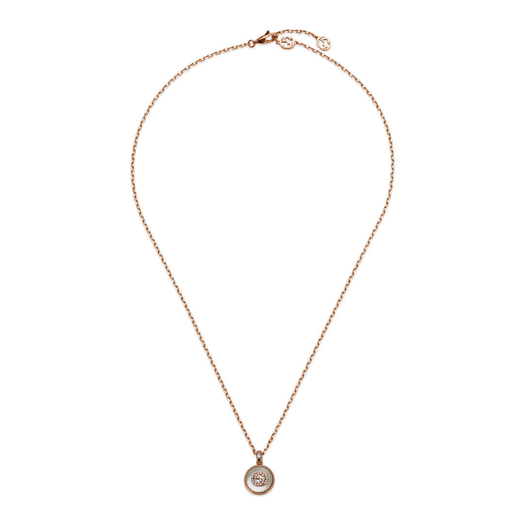 The Gucci Interlocking G 18K yellow gold necklace by GUCCI Fine Jewellery features a circular pendant with diamonds and mother of pearl at the center.