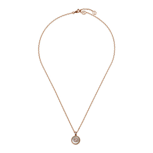 The Gucci Interlocking G 18K yellow gold necklace by GUCCI Fine Jewellery features a circular pendant with diamonds and mother of pearl at the center.