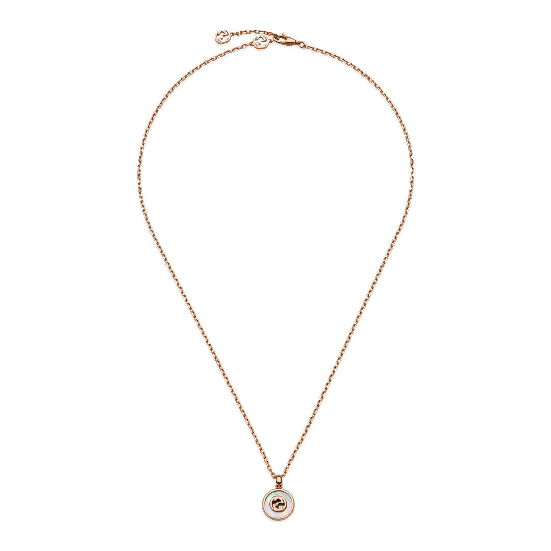 The Gucci Interlocking G 18K Yellow Gold Diamond with Mother of Pearl Necklace Pendant by GUCCI Fine Jewellery features a delicate chain, mother-of-pearl pendant, and sparkling central diamond.