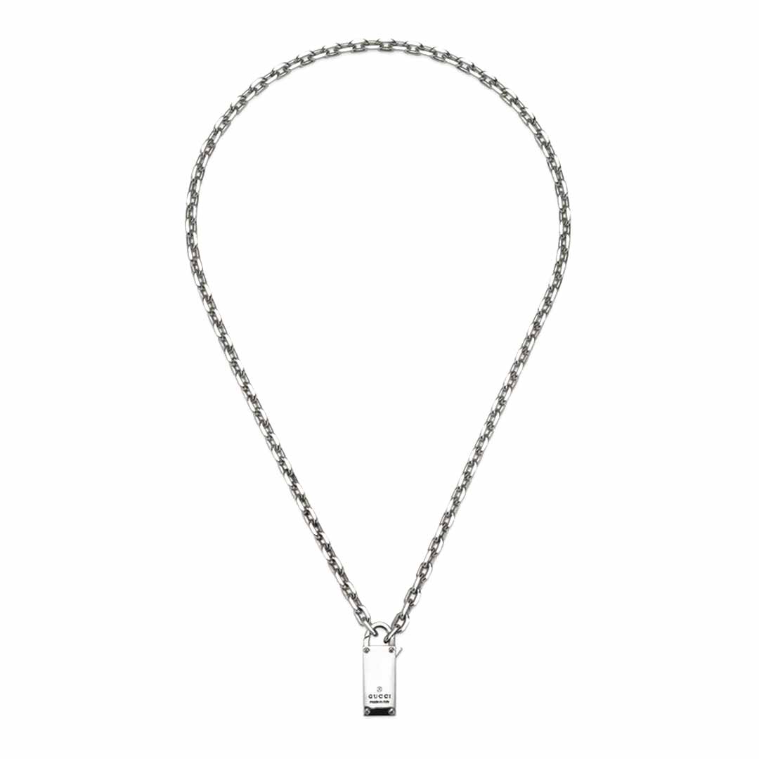 This sterling silver necklace from GUCCI Fine Jewellery features a medium-length chain adorned with a rectangular pendant engraved with the iconic "Gucci" near the base. Embrace the elegance of the Gucci Trademark Sterling Silver Chain Necklace Pendant with Padlock from the Pre-Fall 2024 collection as it gleams with a shiny finish at the center of your ensemble.