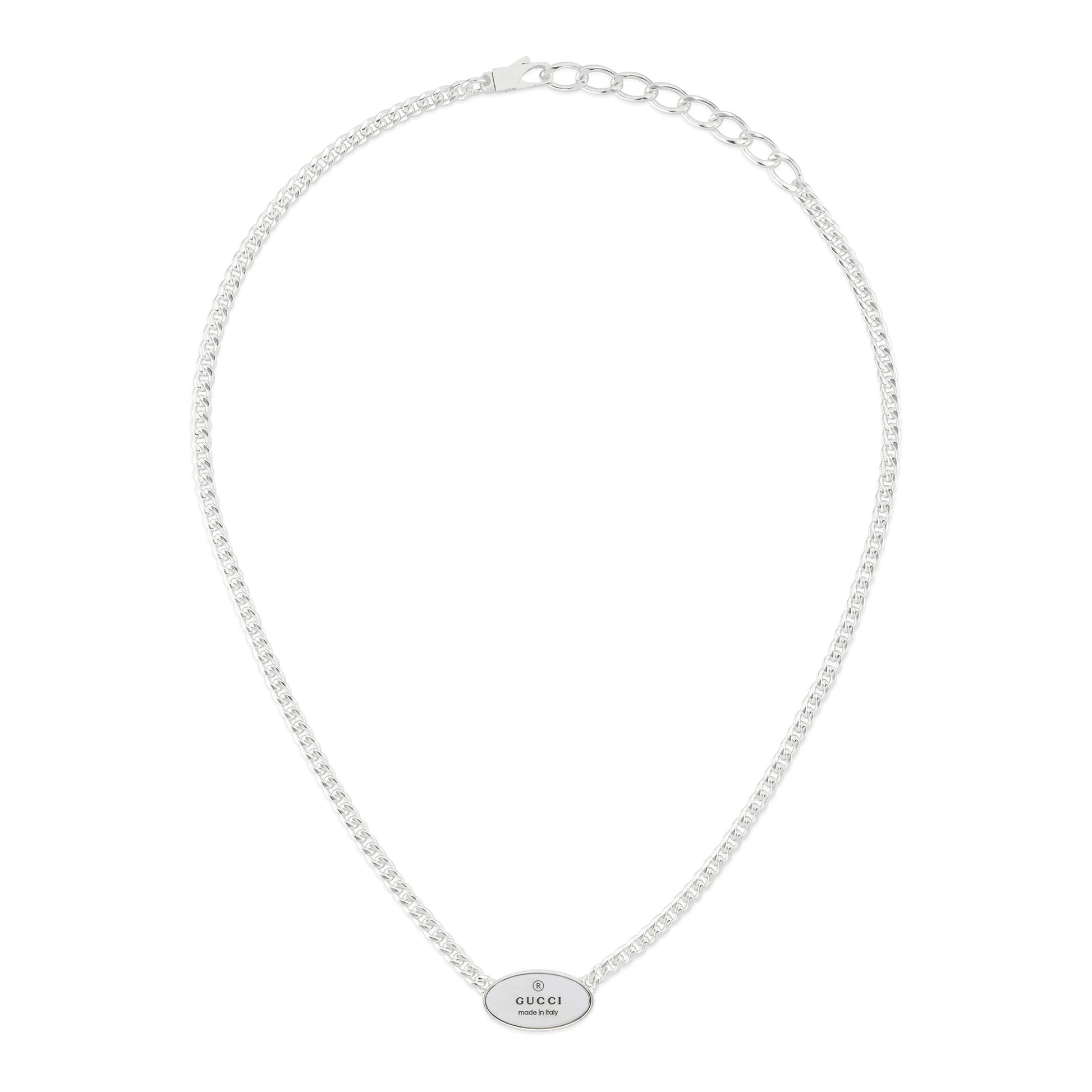 The Gucci Trademark Sterling Silver Tag Necklace Pendant by GUCCI Fine Jewellery features a slender chain, an engraved "GUCCI" oval pendant, and a clasp closure for a simple, elegant look.