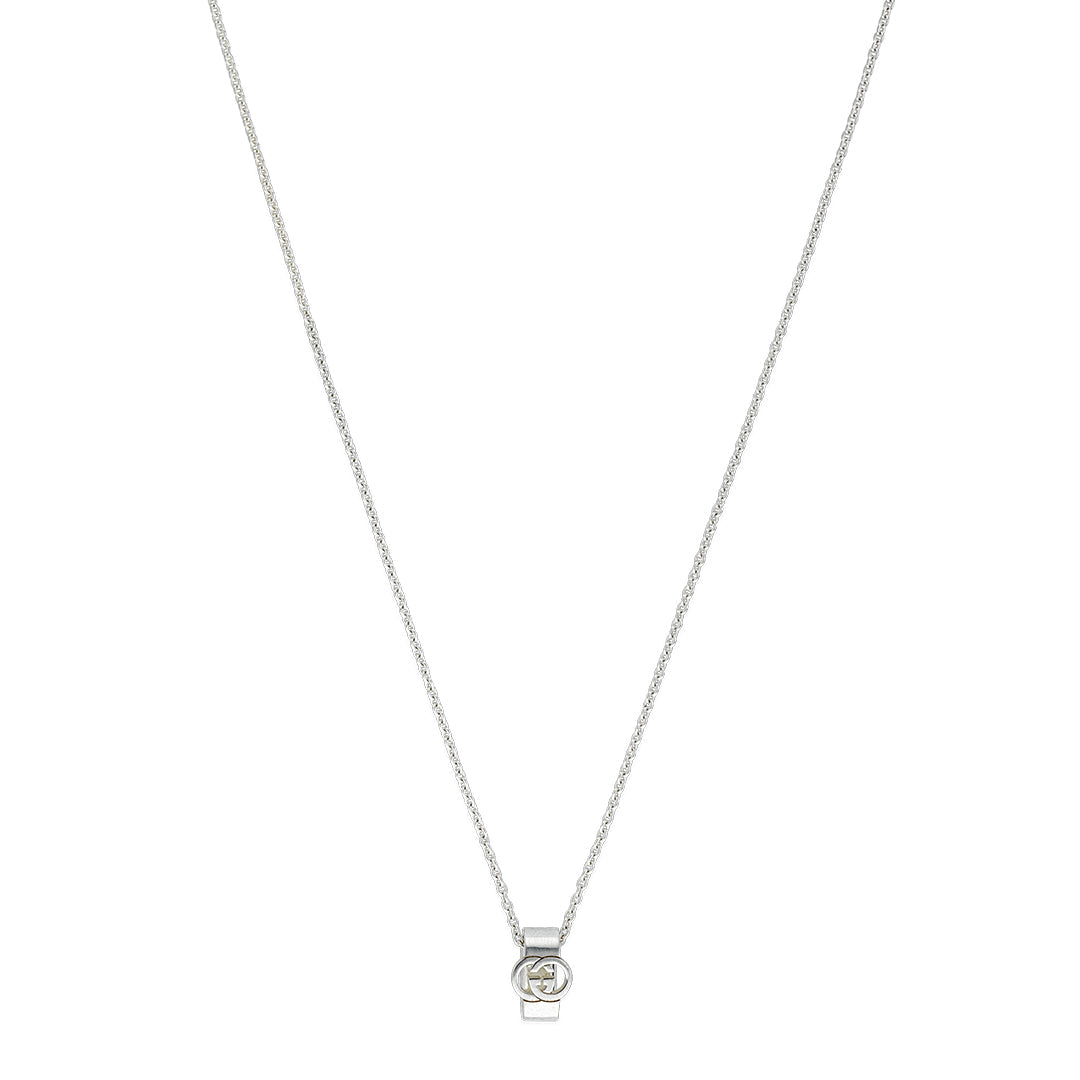 The GUCCI Fine Jewellery Interlocking Sterling Silver Necklace Pendant features a minimalist circular design with a central sparkling stone, inspired by the iconic Interlocking G, displayed on a white background.