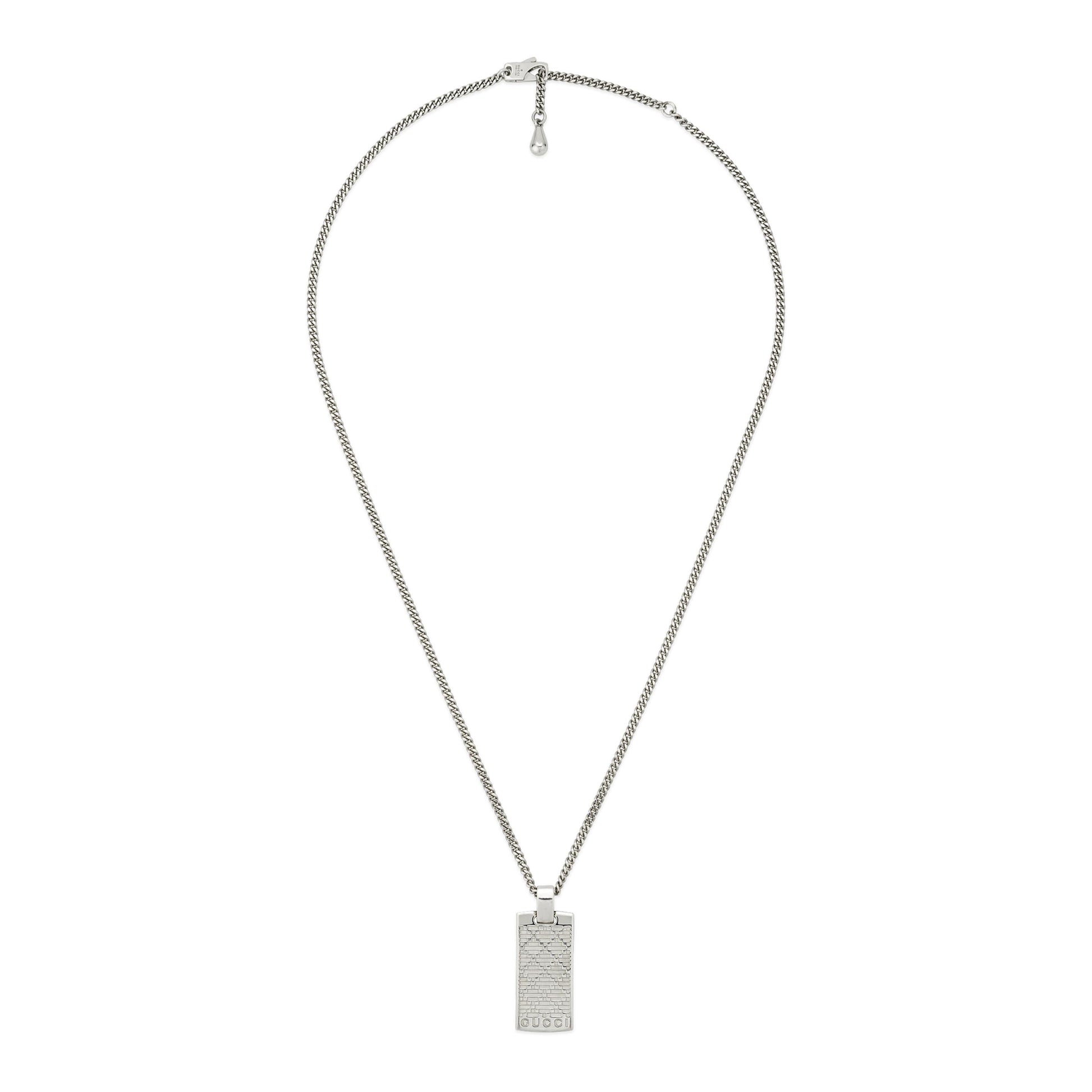 The Gucci Diamante Sterling Silver Tag Chain Necklace Pendant by GUCCI Fine Jewellery features an engraved geometric pattern and "1923" along the edge, making it an elegant addition to any women's jewelry collection.