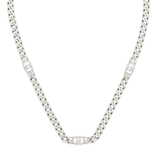 The Gucci Interlocking Sterling Silver Chain Necklace by GUCCI Fine Jewellery features interlocking links and three oval Gucci logo accents. Displayed on a white background, it pairs well with chunky hoop earrings for a bold statement.