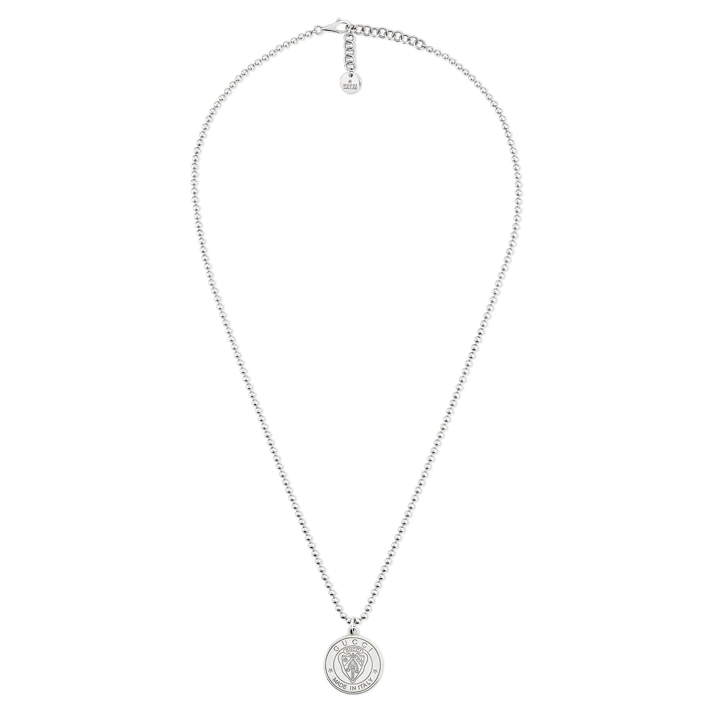 The Gucci Crest Sterling Silver Necklace Pendant by GUCCI Fine Jewellery features a detailed round pendant inspired by the Gucci crest, an adjustable clasp, and a small tag at the end.