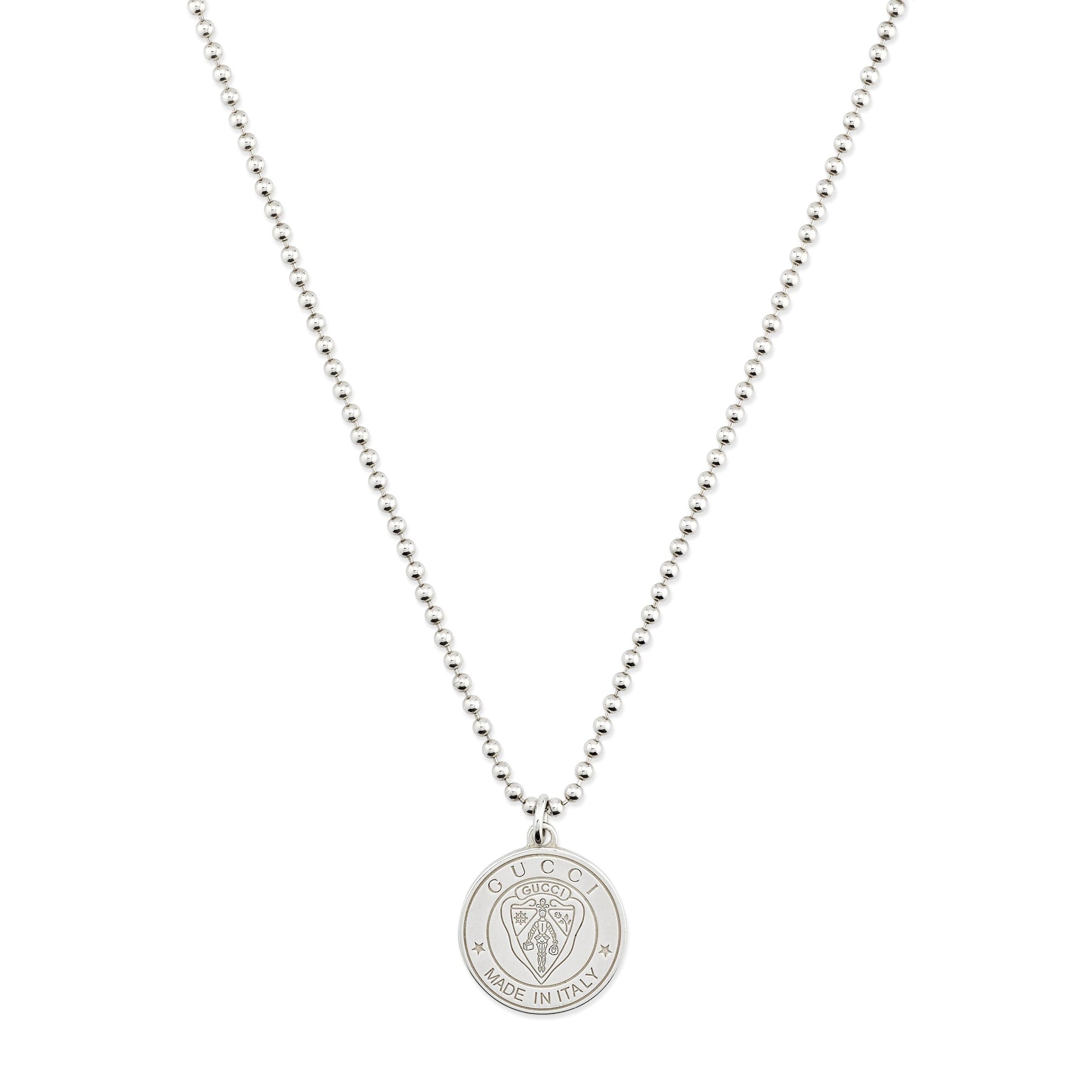 The Gucci Crest Sterling Silver Necklace Pendant by GUCCI Fine Jewellery features a round pendant engraved with a lion’s head and the signature crest, offering refined elegance on a white background.