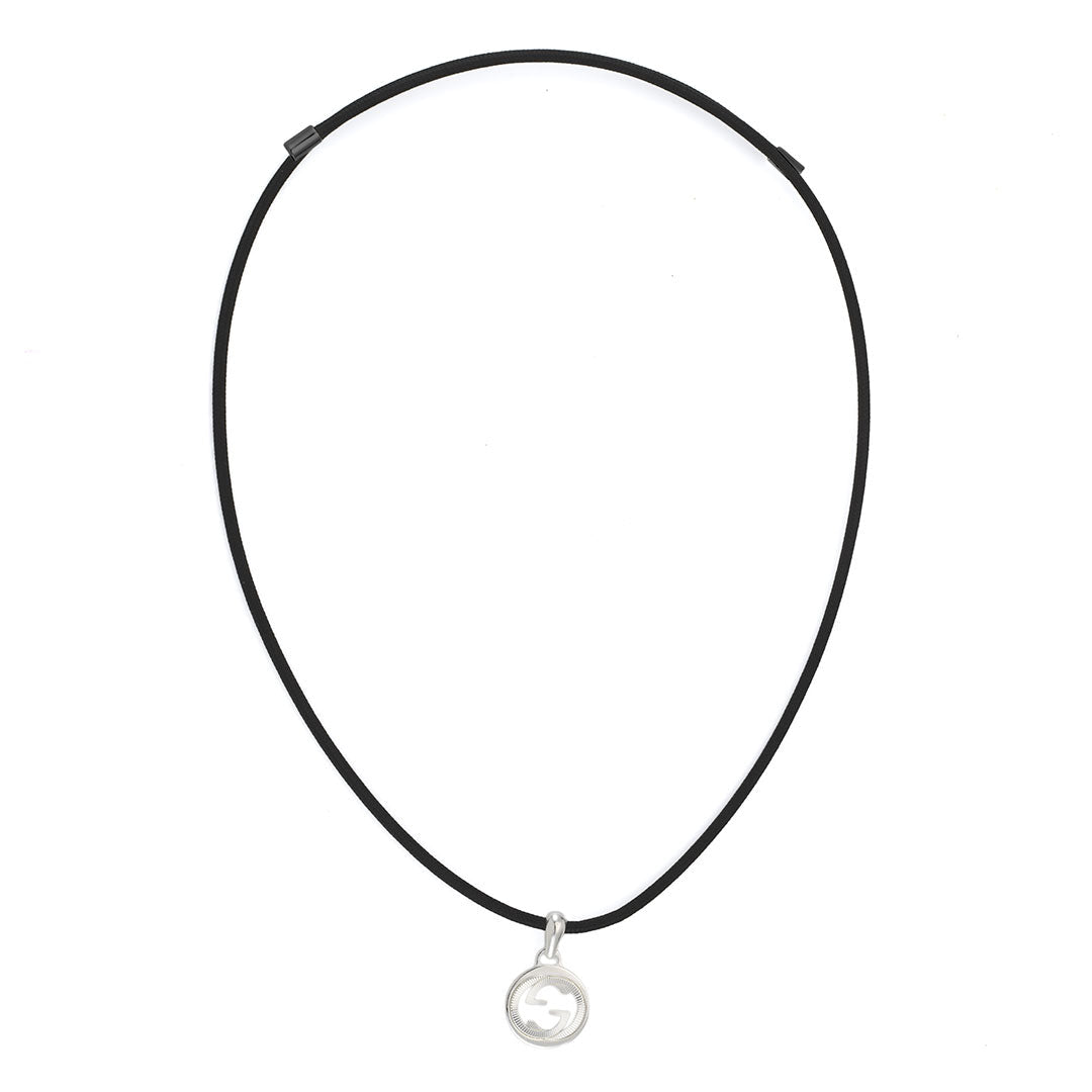 A Gucci Interlocking Cotton Cord with Sterling Silver Necklace Pendant by GUCCI Fine Jewellery is displayed on a white background. The necklace features a black cotton cord and a small round 925 sterling silver pendant with an intricate cut-out interlocking design. Available in open sizes for the perfect fit.