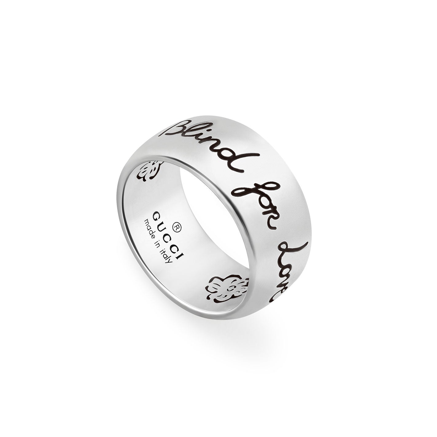 This Gucci Blind For Love Sterling Silver Ring from GUCCI Fine Jewellery features intricate floral motifs and is engraved with "Blind for Love." The interior highlights its exceptional craftsmanship with the inscription "Gucci made in Italy.