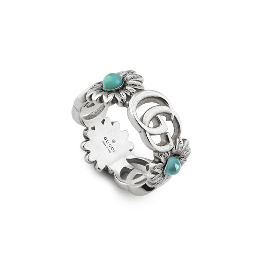 A sterling silver ring from GUCCI Fine Jewellery, featuring an intricate floral design with blue topaz stones, turquoise resin accents, and a central Double G logo. The interior of the ring is engraved with "GUCCI" and hallmarks.