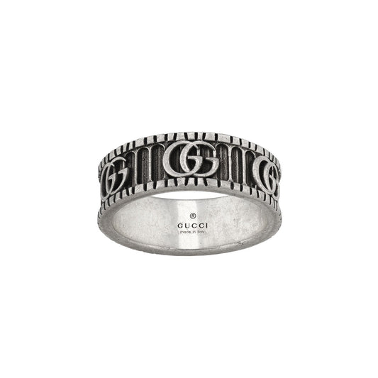 The Gucci Double G Sterling Silver Ring, by GUCCI Fine Jewellery, features embossed Double G letters encircling the band with intricate grooves between each one. Inside, it proudly reads "GUCCI, Made in Italy," echoing the timeless elegance of an archival Gucci belt.