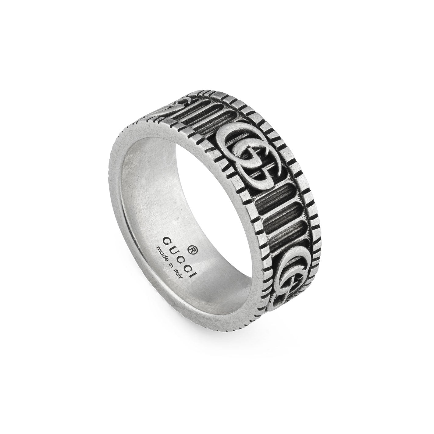 The Gucci Double G Sterling Silver Ring by GUCCI Fine Jewellery features detailed engravings of the iconic Double G logos along with vertical ridges. The interior of the ring has "GUCCI" and "Made in Italy" stamps, echoing the classic design of a famous Gucci belt. It is displayed at a slight angle against a plain white background.