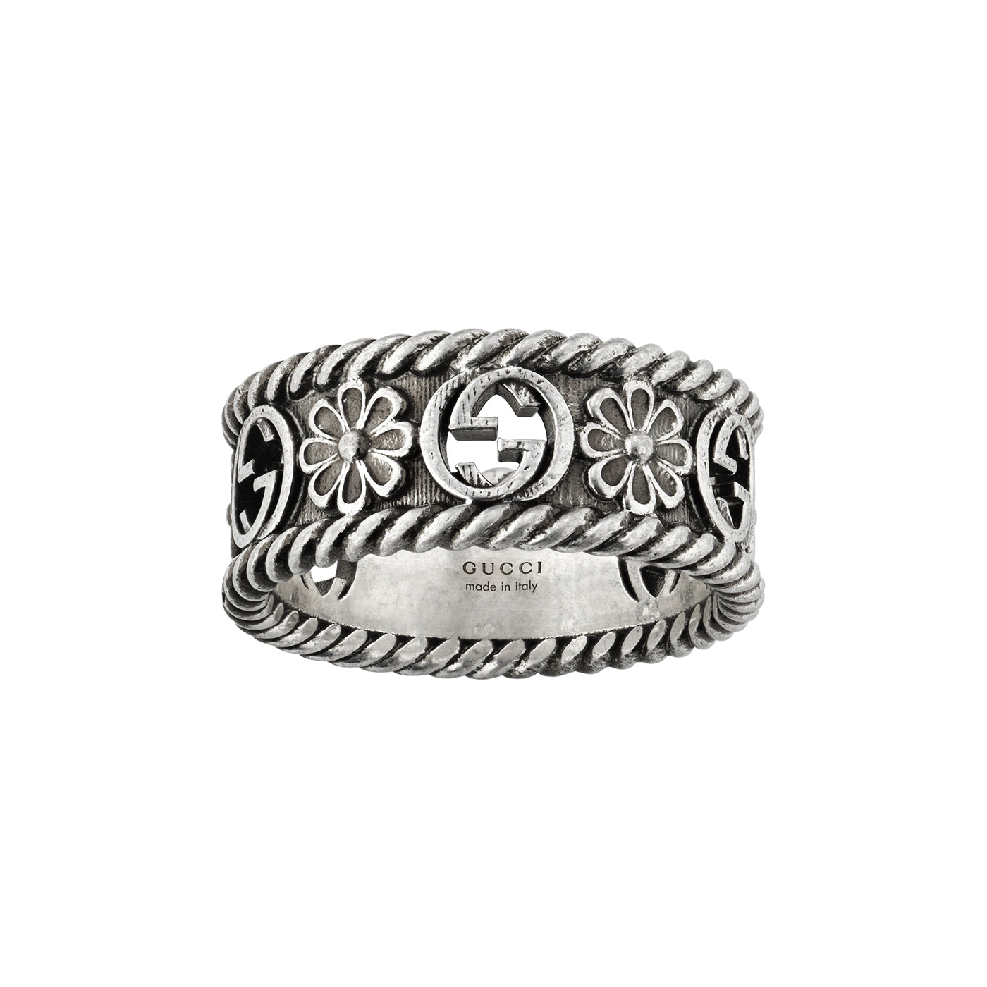 The Gucci Interlocking G Sterling Silver Ring by GUCCI Fine Jewellery features exquisite floral designs and an interlocking G logo at its center. The band boasts intricate details with a rope-like border, while the inside bears the elegant engravings of "GUCCI" and "made in Italy," representing timeless elegance.