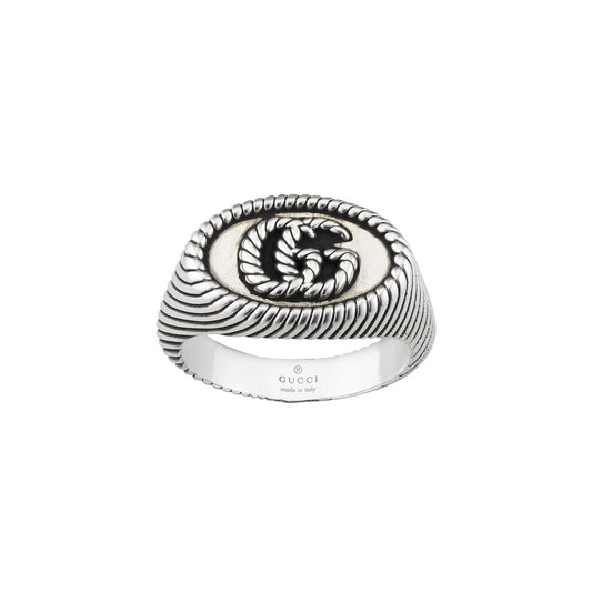 The Gucci Double G Chevalier Aged Sterling Silver Ring from GUCCI Fine Jewellery highlights intricate rope-like detailing and features a prominent double G emblem on the front, beautifully encapsulating Italian elegance and craftsmanship.