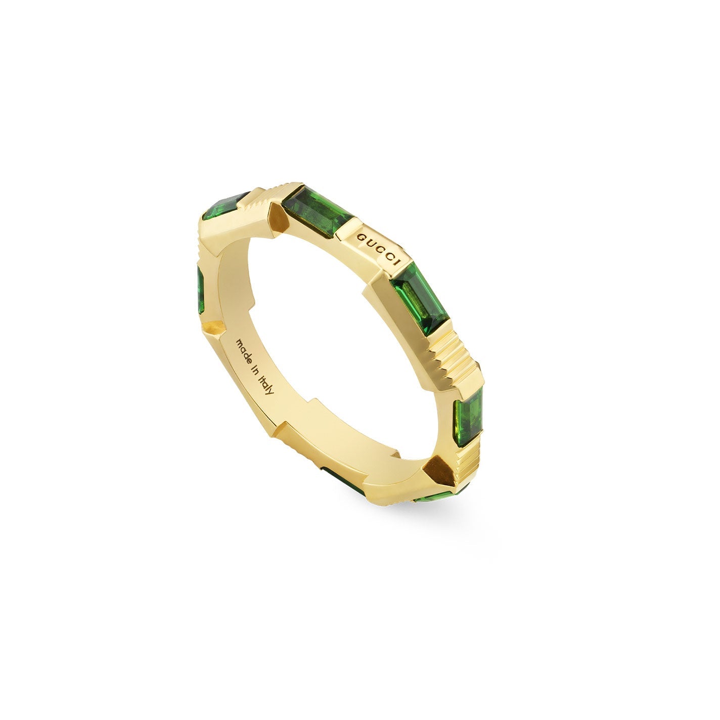 The Gucci Link to Love Tourmaline 18K Yellow Gold Ring from GUCCI Fine Jewellery showcases rectangular green emeralds evenly spaced around the band, highlighting its luxurious design. The inside of the band is impressively engraved with "Gucci" and "made in Italy," embodying the iconic Gucci Link to Love collection.