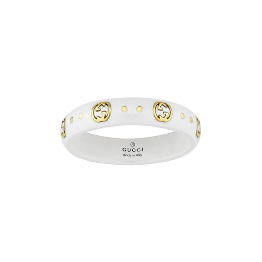 The GUCCI Fine Jewellery Icon Interlocking G White Zarconia and 18K Yellow Gold Ring exhibits exceptional artistry with its gold double G logos and elegant yellow gold dot accents circling the band. Crafted in Italy, this piece highlights iconic elements like the Interlocking G symbols.
