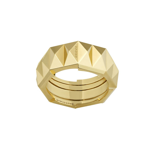 A geometric, gold-toned ring with a studded, angular design. The exquisite craftsmanship complements the brand logo engraved on its surface, reminiscent of the elegance found in Gucci Link to Love collections by GUCCI Fine Jewellery.