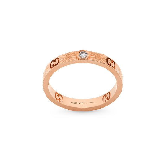 The Gucci Icon Heart 18K Rosé Gold Diamond Ring by GUCCI Fine Jewellery features engraved GG motifs and a central round diamond on the band, with the interior showcasing the brand's name.