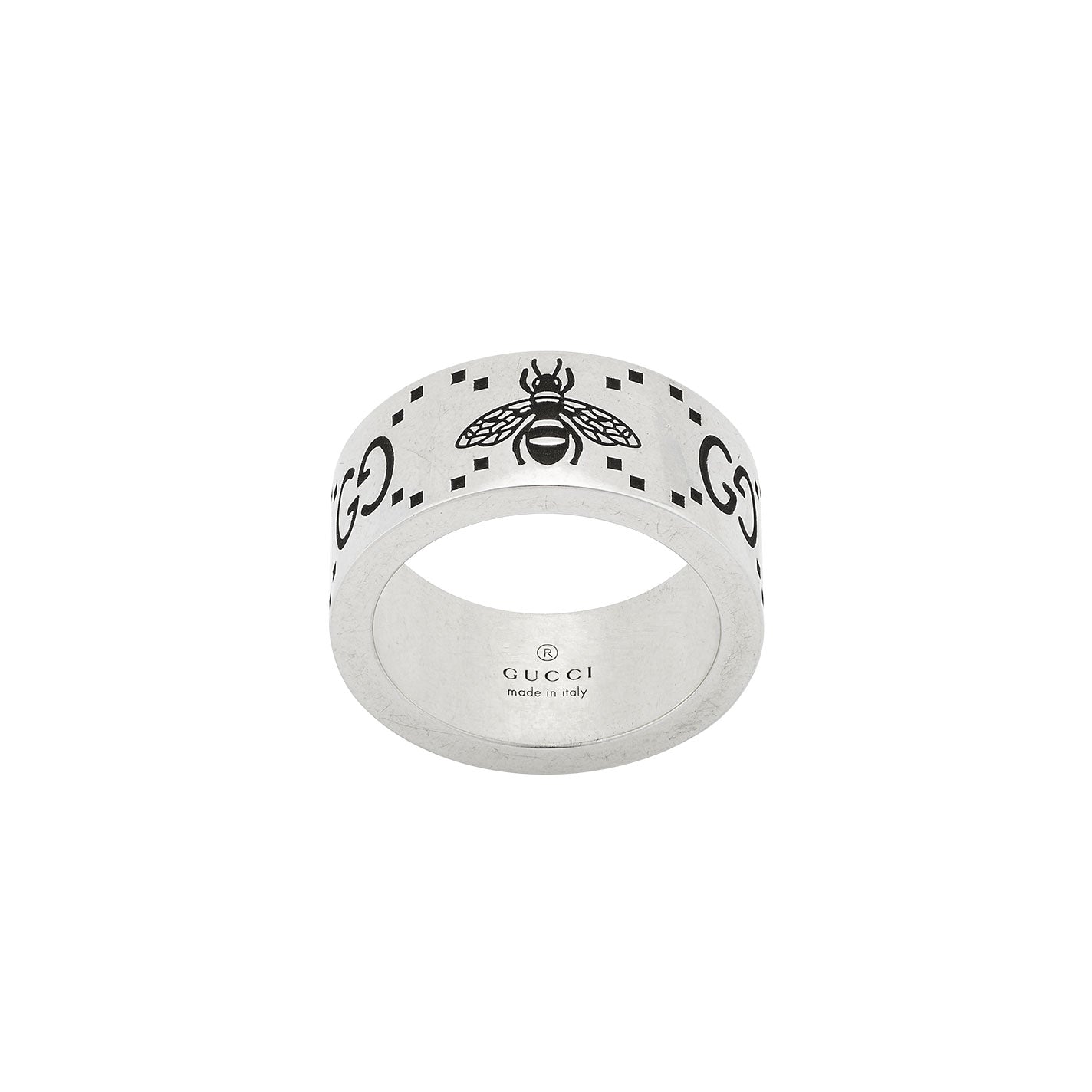 The Gucci GG And Bee Engraved Wide Sterling Silver Ring from GUCCI Fine Jewellery showcases a bee design surrounded by the GG motif, with "Made in Italy" inscribed inside. Its thick band and minimalist style make it a sophisticated addition to any jewelry collection.