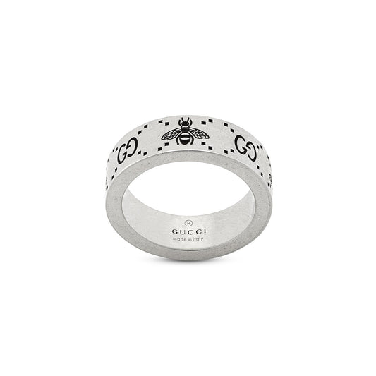 Introducing the Gucci GG and Bee Engraved Wide Sterling Silver Ring, a fine creation from GUCCI Fine Jewellery. This ring features detailed bee engravings alongside the iconic "GG" motif. Inside, it proudly displays the "GUCCI" brand name and a "made in Italy" inscription. The design elegantly balances simplicity and luxury, reflecting a creative blend of artistic craftsmanship.