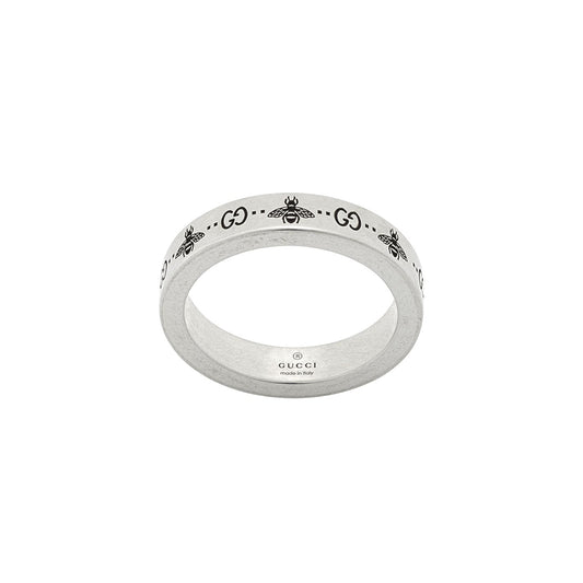 The Gucci GG and Bee Engraved Thin Sterling Silver Ring from GUCCI Fine Jewellery showcases the iconic "GG" letters alongside intricate bee motifs, with "GUCCI" and "Made in Italy" stamped on the interior.