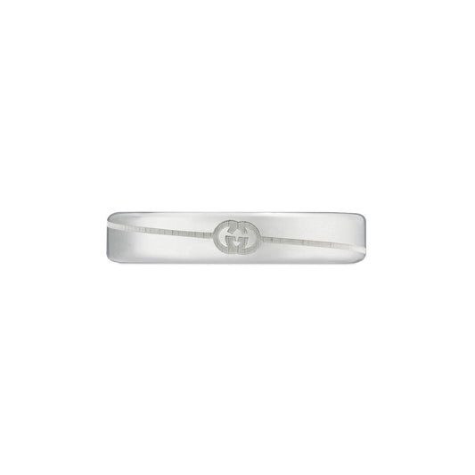 The Gucci Diagonal Interlocking G Sterling Silver Thin Ring by GUCCI Fine Jewellery features the signature interlocking "G" engraving prominently displayed on a sleek, minimalist white background.