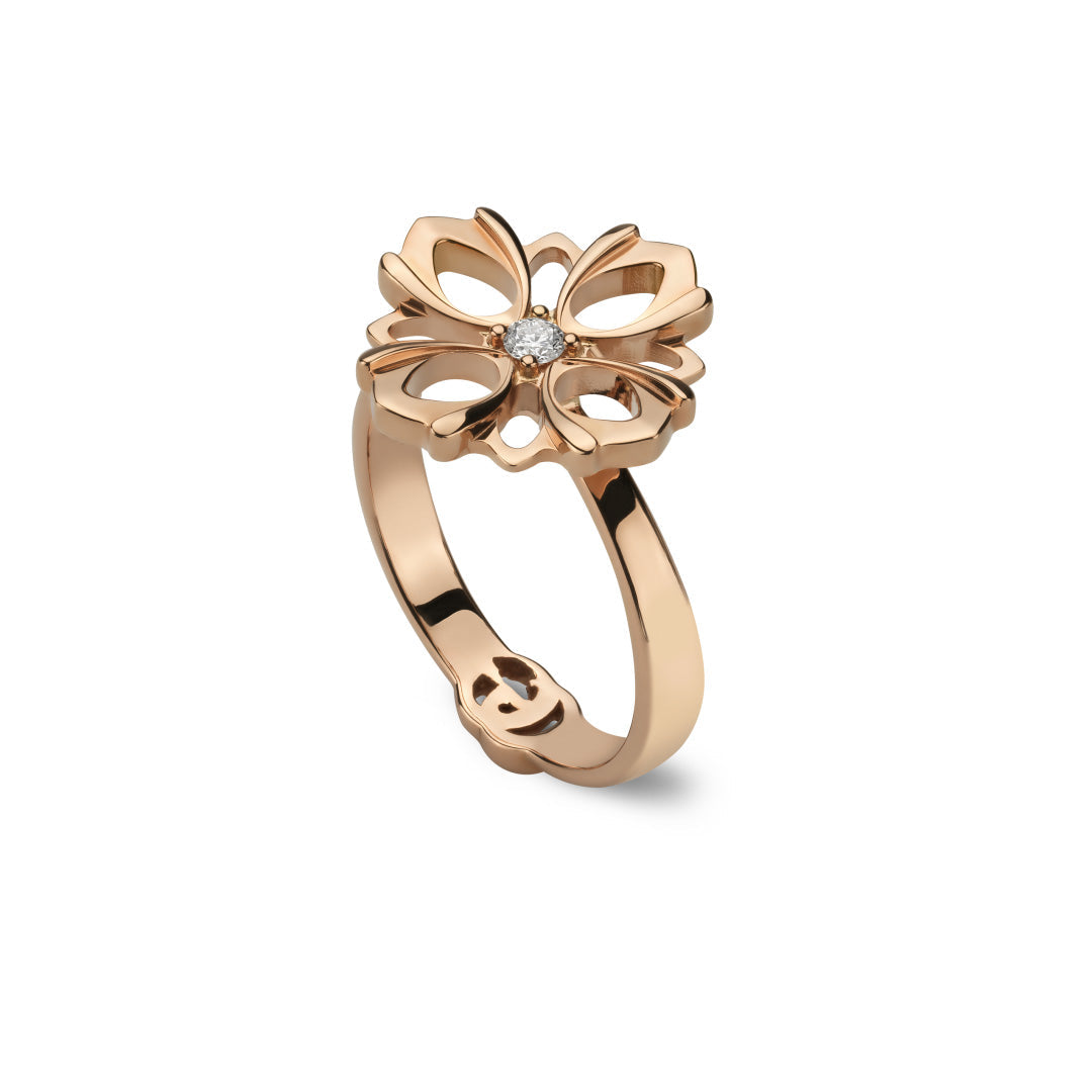The Gucci Flora 18K Rose Gold Diamond Fashion Ring, designed by GUCCI Fine Jewellery with a butterfly motif and a central diamond resembling a delicate diamond flower, is angled elegantly against a white background.