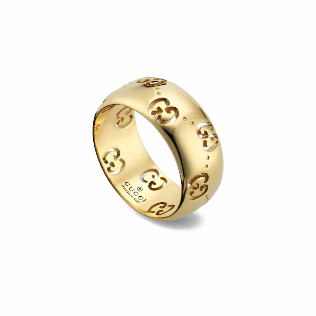 The Gucci Icon GG 18K Yellow Gold GG Wide Ring, with its striking interlocking pattern cutouts, elegantly stands out against the white background. This piece exemplifies GUCCI Fine Jewellery's commitment to style and craftsmanship while adhering to the Responsible Jewelry Council's standards.