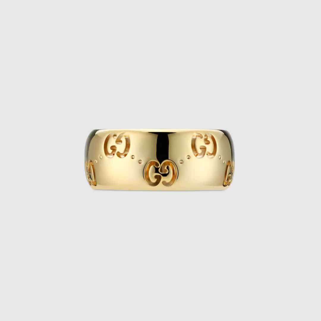The Gucci Icon GG 18K Yellow Gold GG Wide Ring from GUCCI Fine Jewellery showcases an embossed interlocking "G" pattern, highlighting the brand's elegance. This ring features a smooth, polished surface with a gently rounded shape set against a plain light gray background.