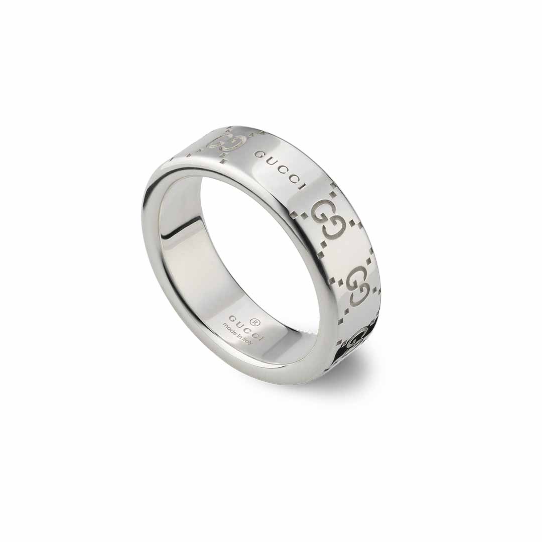 The Gucci Signature GG Sterling Silver Wide Ring from GUCCI Fine Jewellery features the brand's iconic name and interlocking GG motif engraved on its surface, all presented in a sleek, polished finish with a modern design.