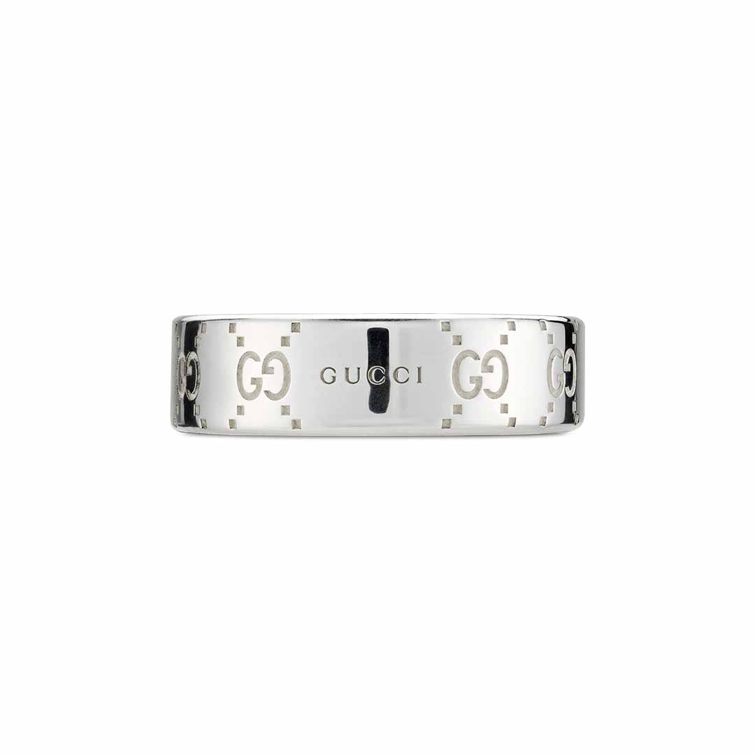 The Gucci Signature GG Sterling Silver Wide Ring from GUCCI Fine Jewellery is adorned with the iconic logo and interlocking GG motif designs engraved around its shiny and reflective band, highlighting stylish branding details.