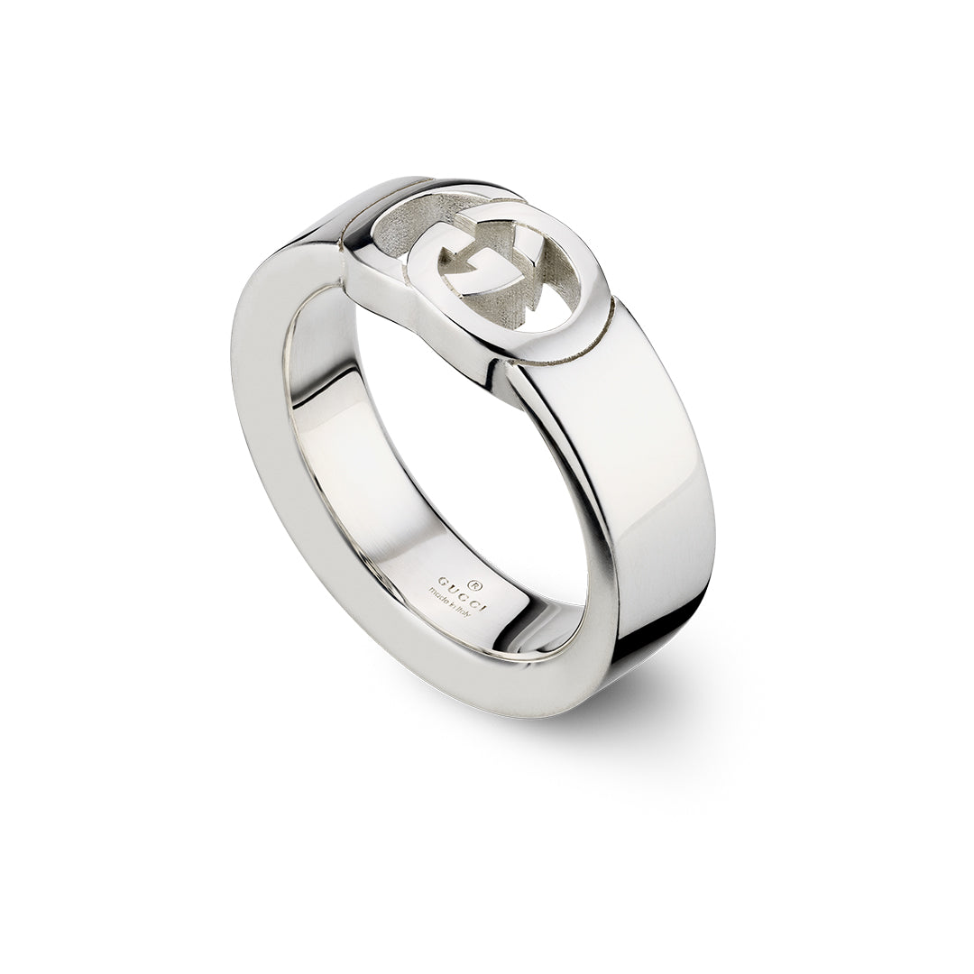 The Gucci Interlocking G Sterling Silver Ring by GUCCI Fine Jewellery features a bold, flat band with the iconic Interlocking G logo on top, shown against a white background.