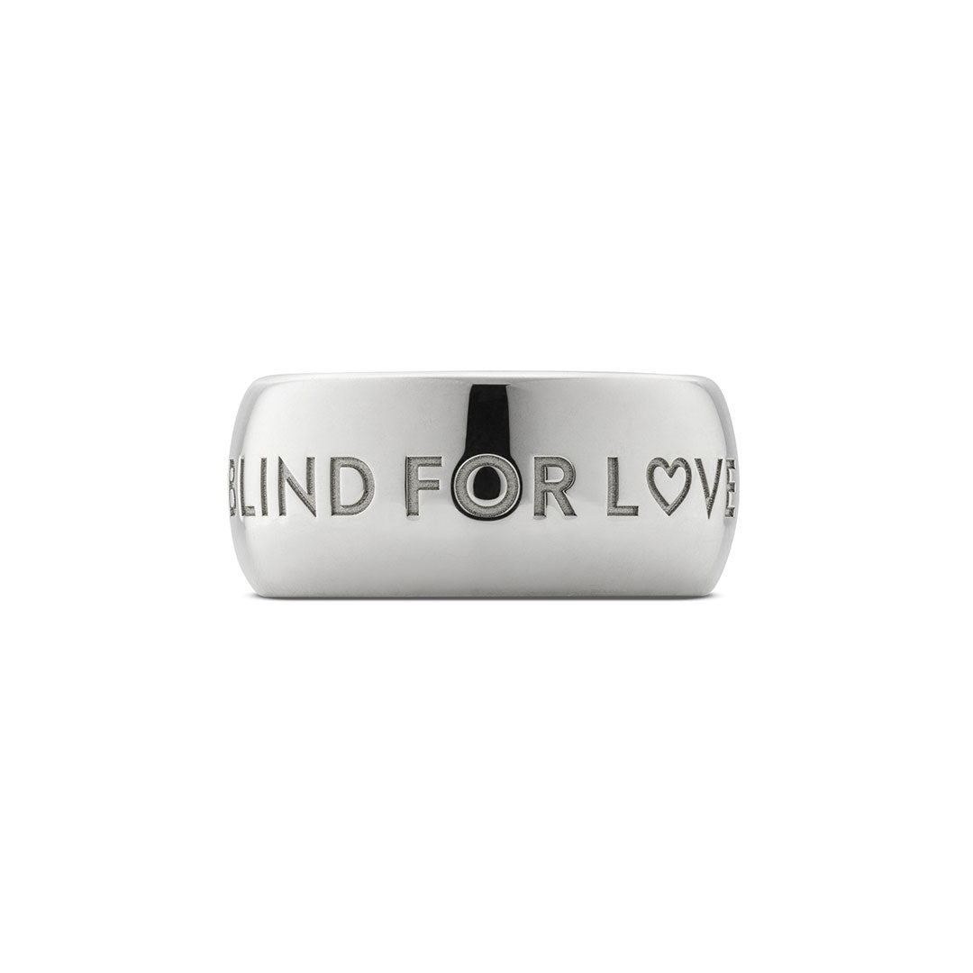 The GUCCI Fine Jewellery Blind For Love 9mm Sterling Silver Ring features "BLIND FOR LOVE" engraving with a heart symbol in place of the "O" in LOVE.