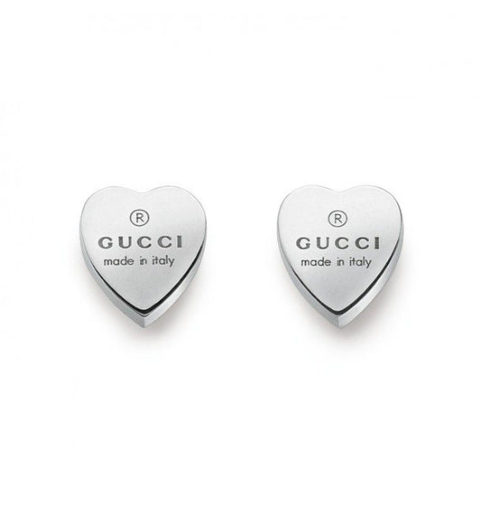 The Gucci Trademark Heart Sterling Silver Stud Earrings, crafted from 925 sterling silver by GUCCI Fine Jewellery, feature the "GUCCI® made in Italy" embossing. These elegant earrings are displayed against a white background.