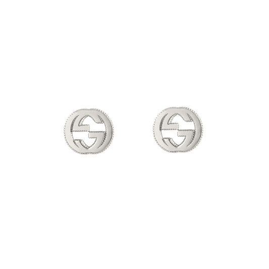 Introducing the Gucci Interlocking G Sterling Silver Stud Earrings from GUCCI Fine Jewellery. These small, round earrings are crafted from 925 sterling silver and showcase a striking cut-out design of the iconic interlocking G logo. The textured edge lends a subtle elegance as they beautifully reflect light against a white background.